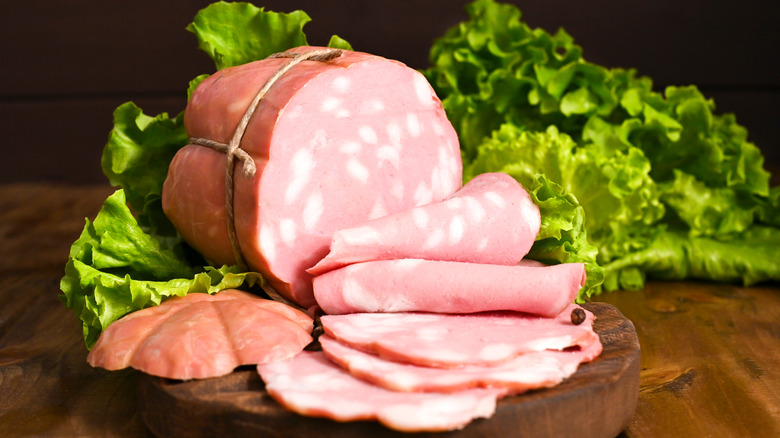 Sliced mortadella on a wooden table