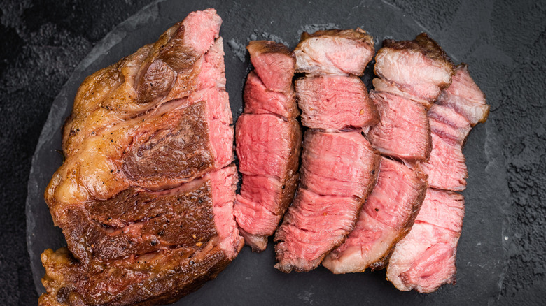 Sliced beef chuck eye roast on a marble plate