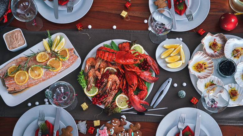 Overhead view of a seafood feast with lobster, shrimp, salmon, scallops and more.