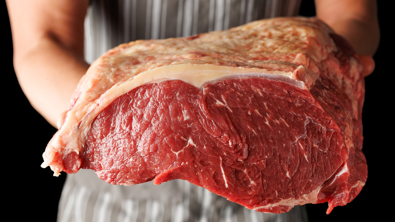 butcher holding beef sirloin