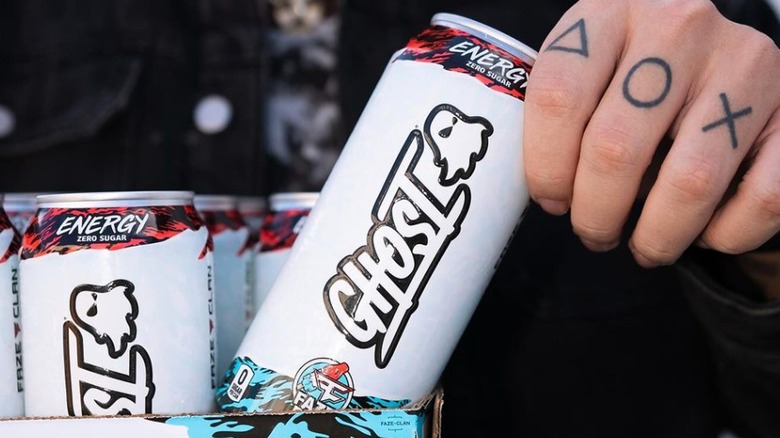 A hand holding a can of Ghost Energy drink