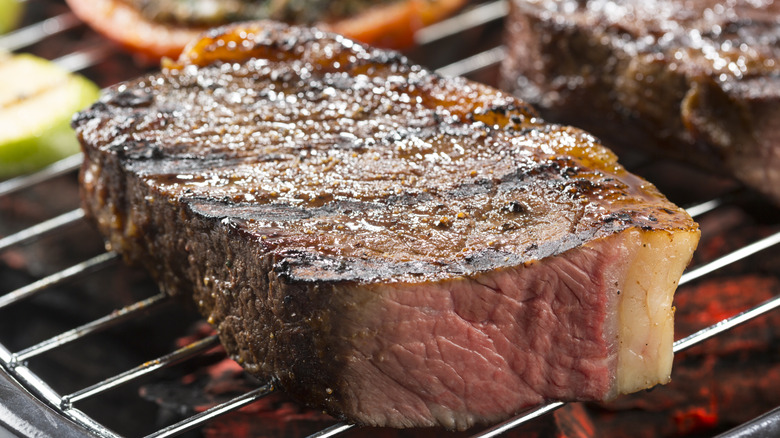 Grilling very large steak with big layer of fat