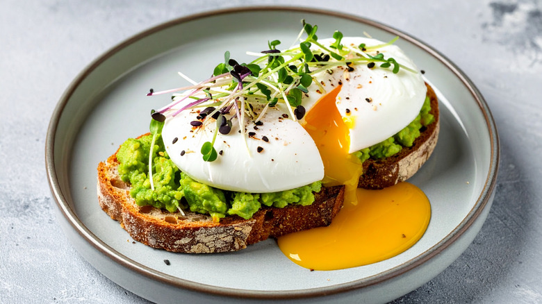 a slice of sourdough with avocado and poached egg on top