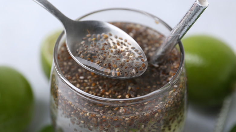 Chia seeds in jar on liquid with spoon