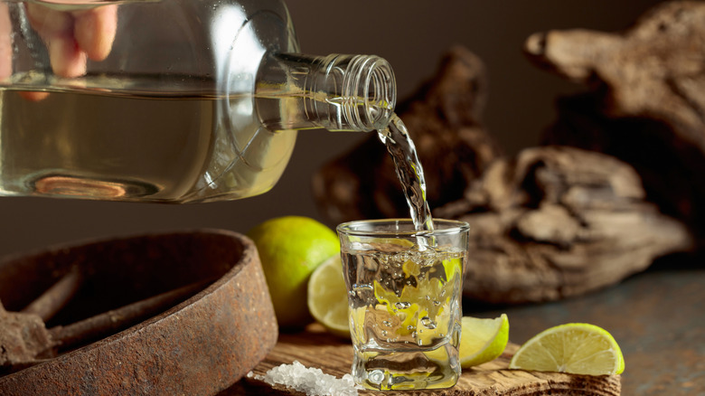 pouring bottle of tequila