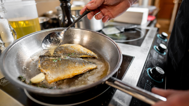 cooking fish in frying pan