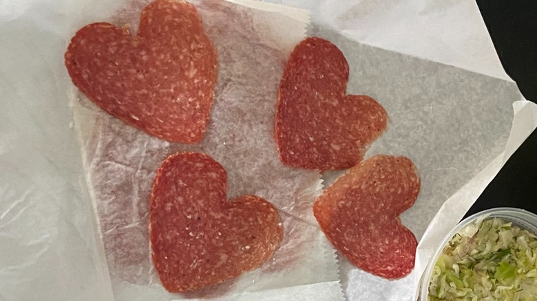 Four slices of heart-shaped salami