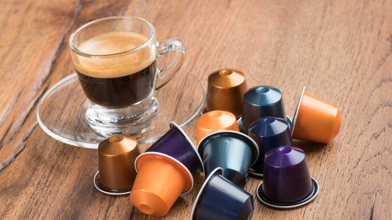 Cup of coffee and capsules 