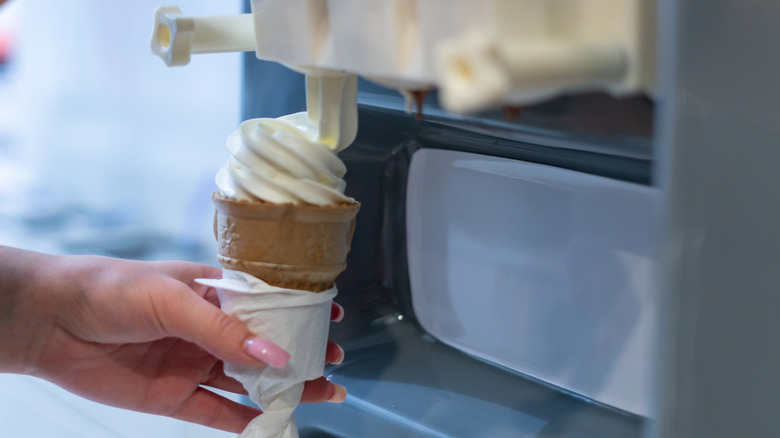 Burger King caramel and strawberry sundaes sit on a wooden counter