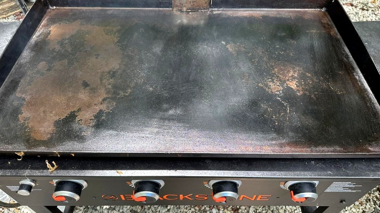 Blackstone griddle surface with areas of brown rust