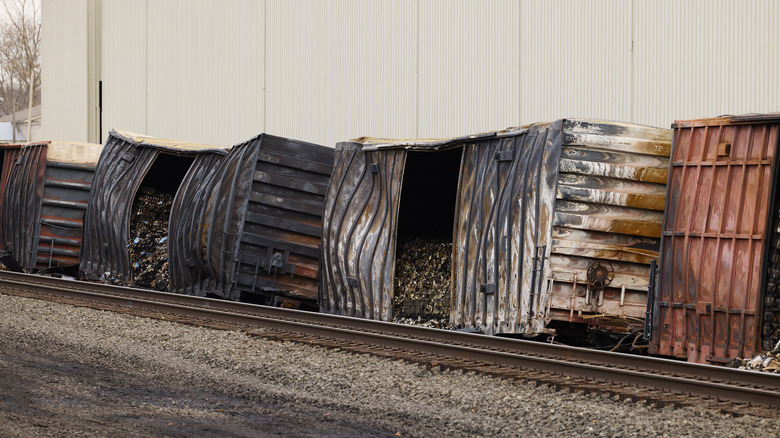 derailed train cars after fire