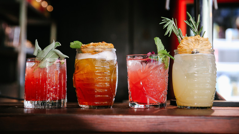 Variety of cocktails lined up on a bar