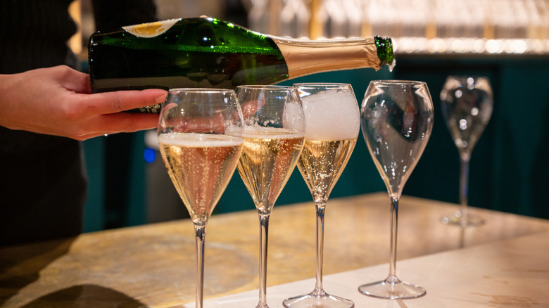 Pouring sparkling wine in restaurant