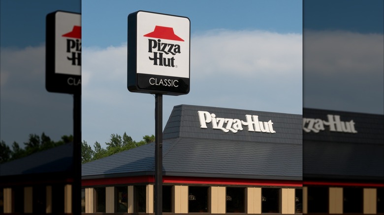 the classic pizza hut logo of the red hat atop the name