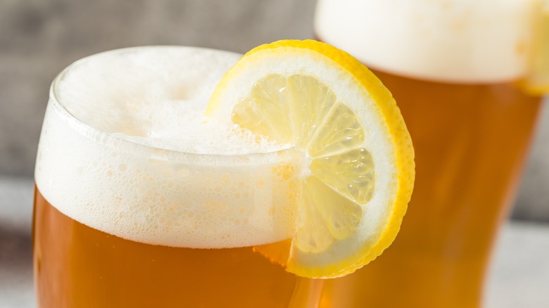 close up of beer with lemon slice