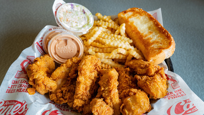 Raising Cane's meal basket with chicken tenders, Texas toast, coleslaw, and sauce cups
