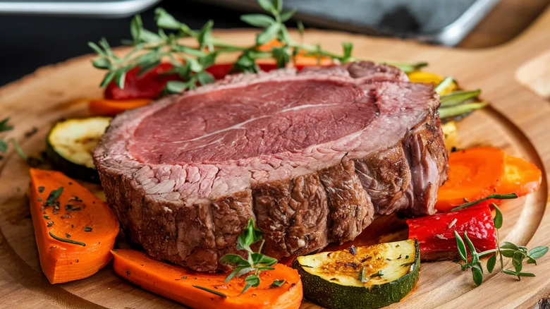 Prime rib on a plate with vegetables