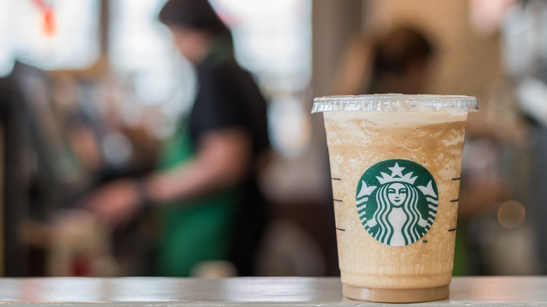 Starbucks drink and employee