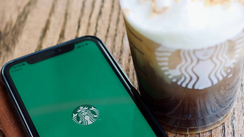 Starbucks app on phone with drink