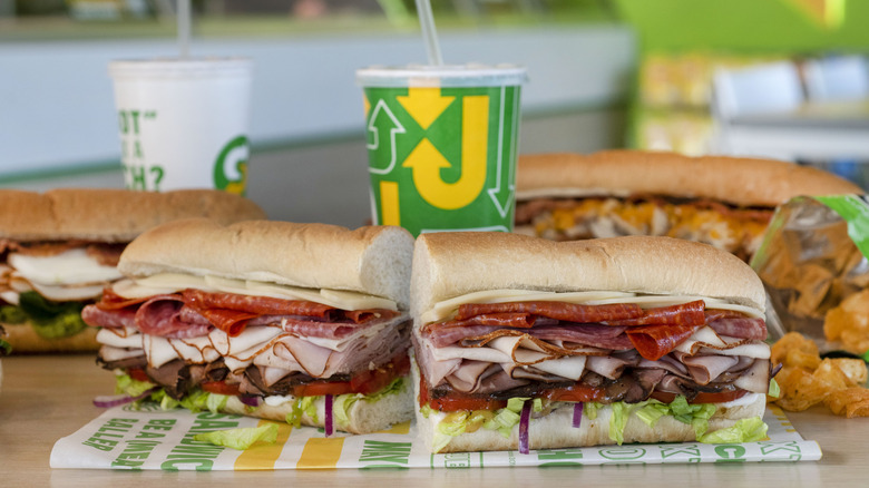 Subway sandwiches and drinks on a table