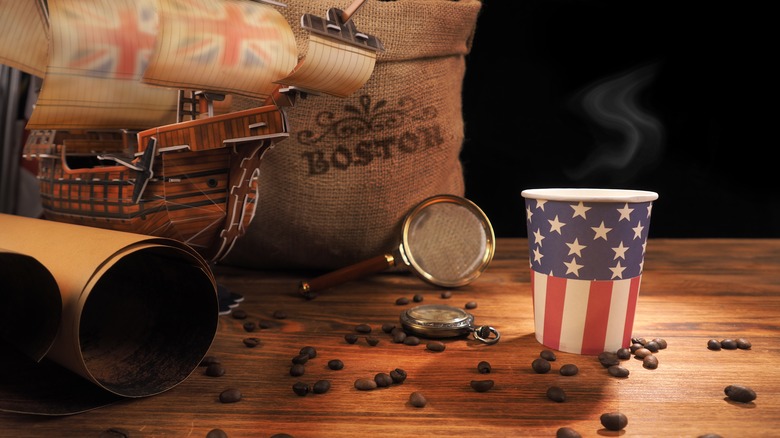 American flag printed coffee cup surrounded by Revolutionary war memorobilia