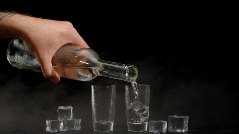pouring vodka into glasses