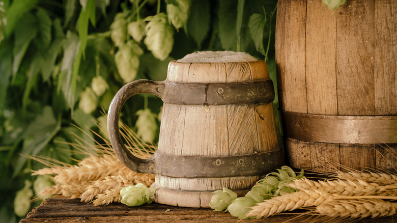 A keg of beer and a wooden mug