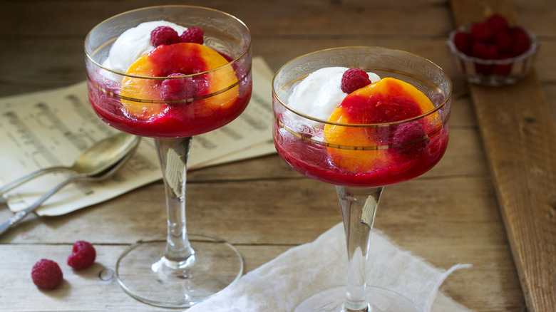 peach melba dessert in stemmed glass