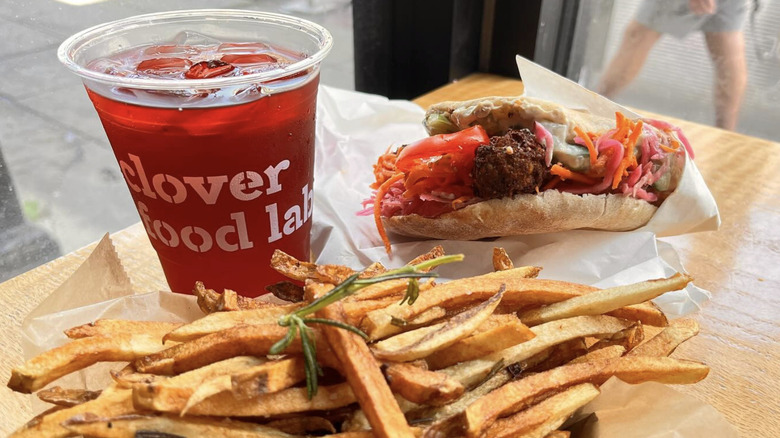 served french fries with red drink and wrap at Clover