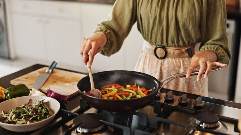 Woman making a stir fry on the stove