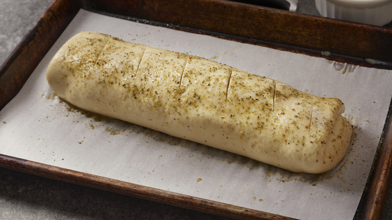 Uncooked stromboli on baking sheet