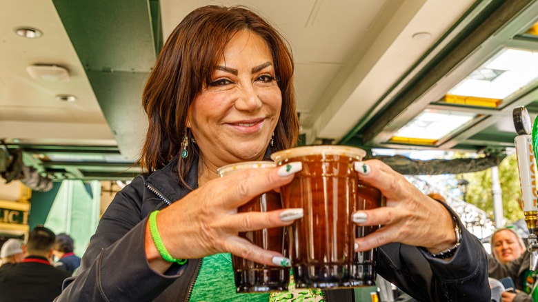 A woman holding Guinness beers