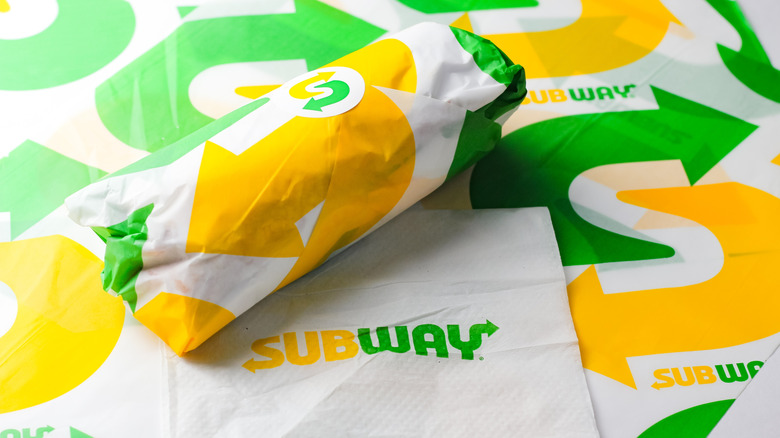 Sub-style sandwich wrapped in Subway branded deli paper