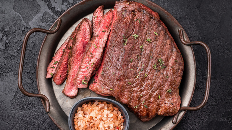 grilled top sirloin steak on silver tray