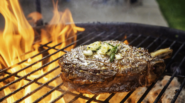 Close-up of a Tomahawk ribeye cooking on the grill