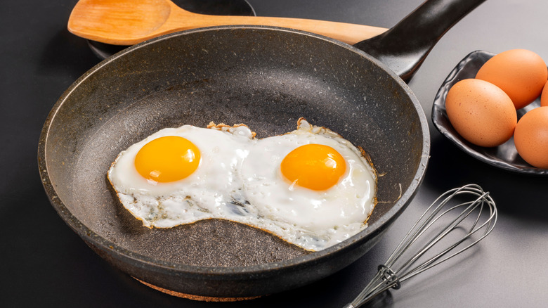 Two eggs in frying pan.