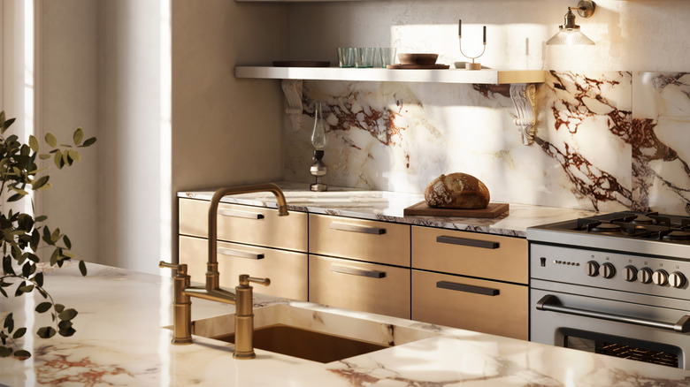 View of a kitchen with marble countertops and beige cabinets