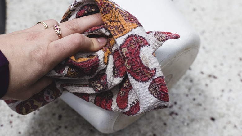 Wiping a Dutch oven with clean cloth