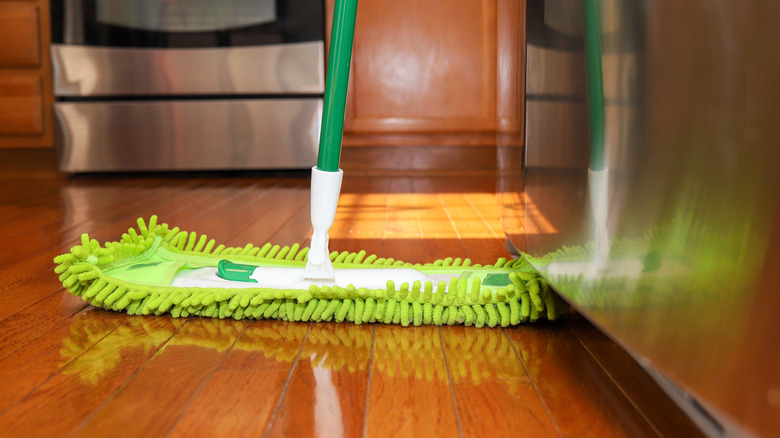 Green duster under fridge