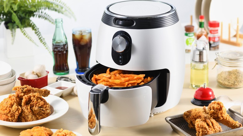 air fryer with french fries and fried chicken