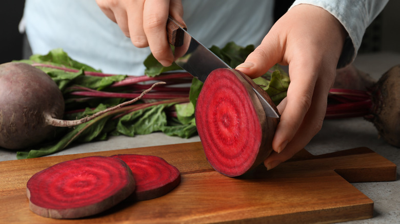 hands cutting beet