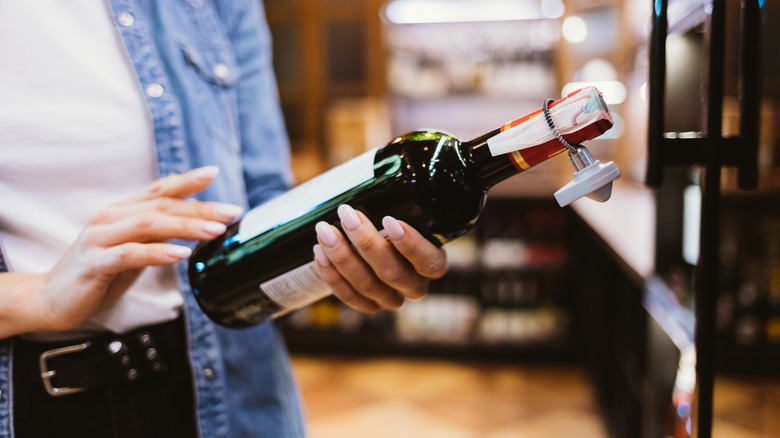 Hands holding wine bottle