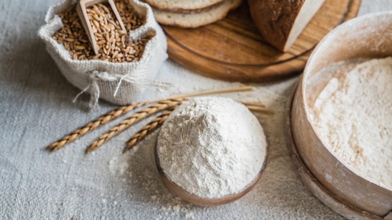 freshly-milled flour next to a bag of wheat and sliced bread