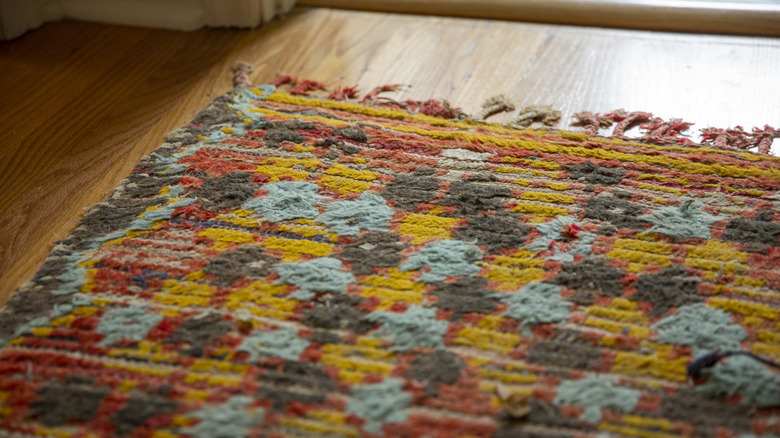 Close-up of a colorful rug placed on wooden flooring