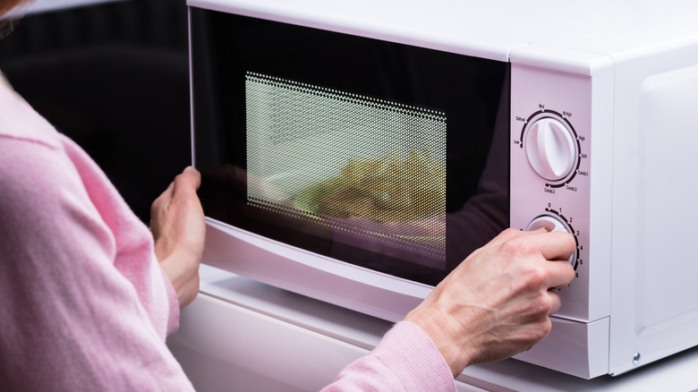 Old microwave on kitchen counter