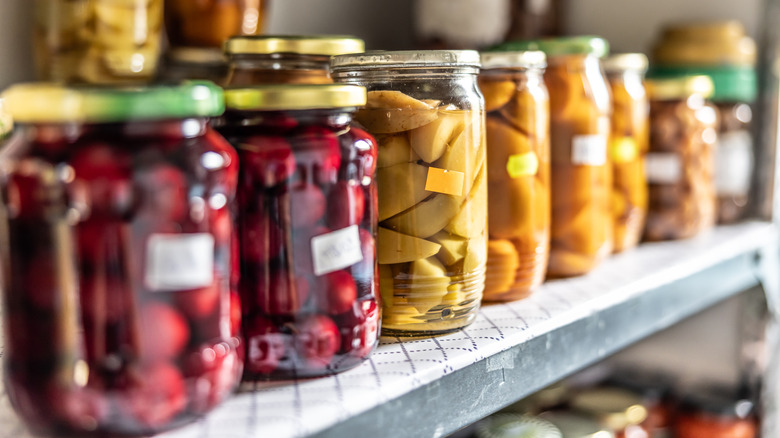 Homemade tape-labelled food jars in a home pantry