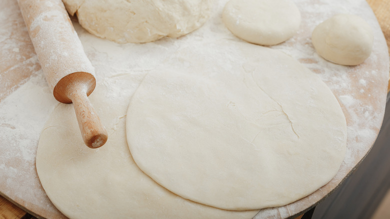 Pizza dough and a rolling pin