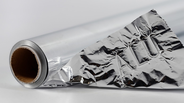 Crumpled, uneven aluminum foil roll.