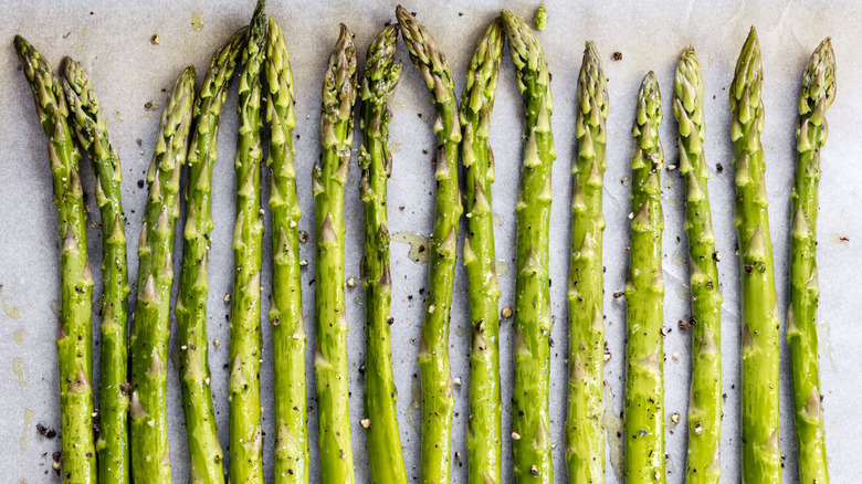 asparagus spears on baking sheet