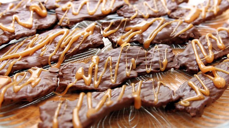 Chocolate covered bacon strips with caramel sauce